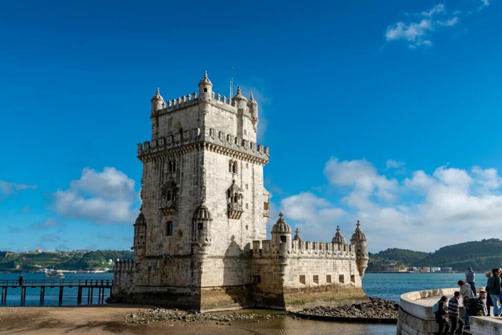 Belem Tower Near the River Under Blue Sky